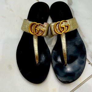 Gold Gucci flip flops